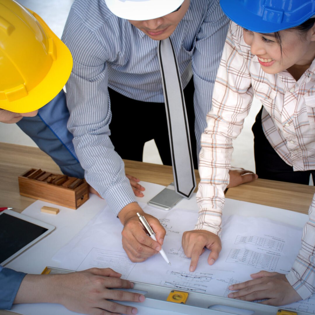 engineer-team-architect-team-looking-paper-plans-at-construction-site